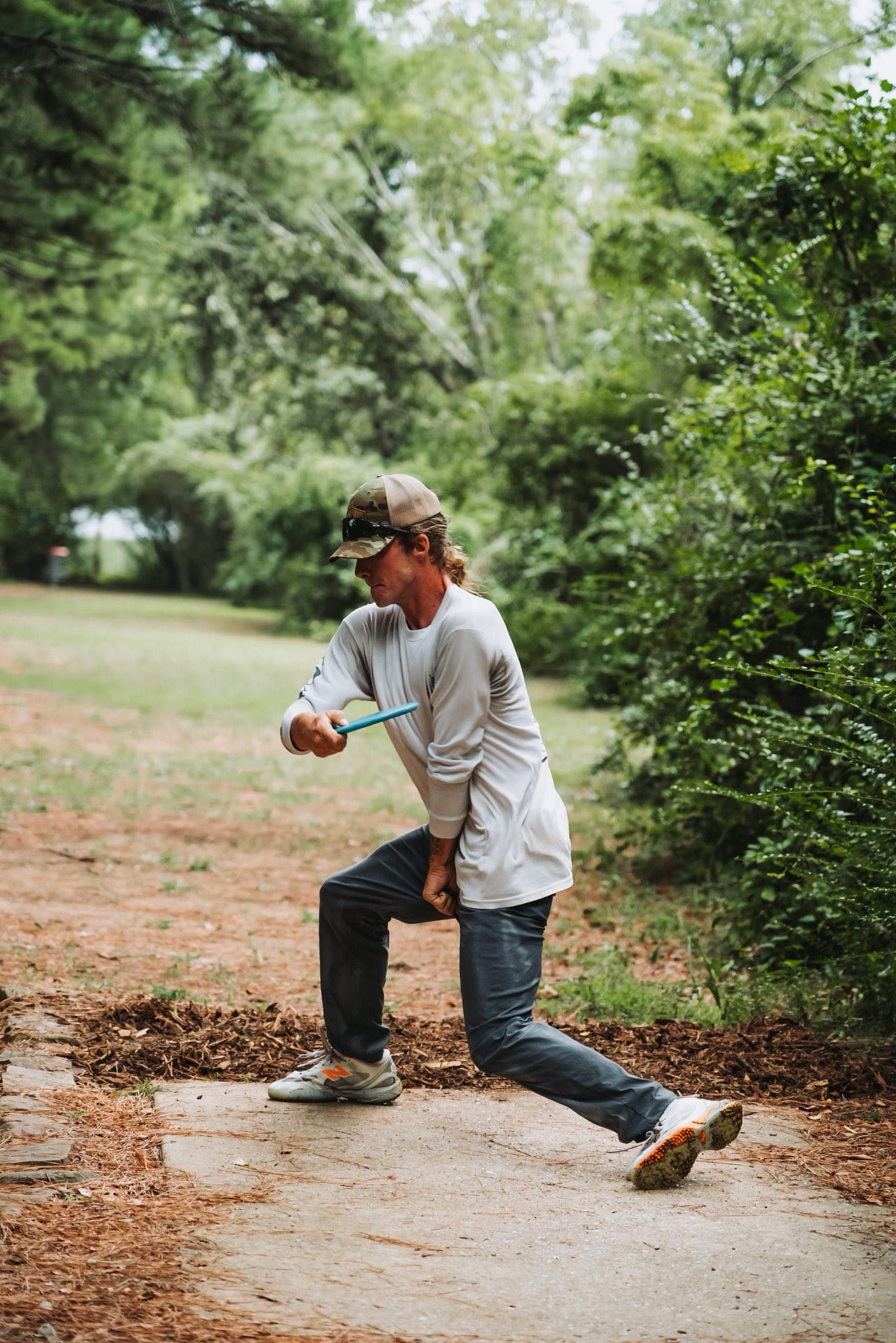 Player lining up a drive on a wooded tee pad